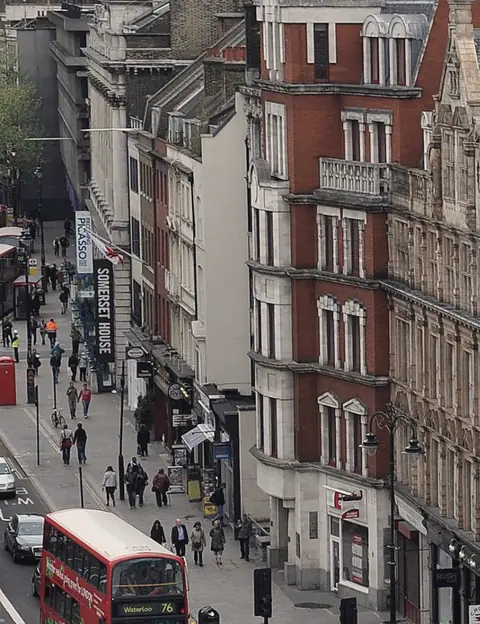 A busy London street with a red bus