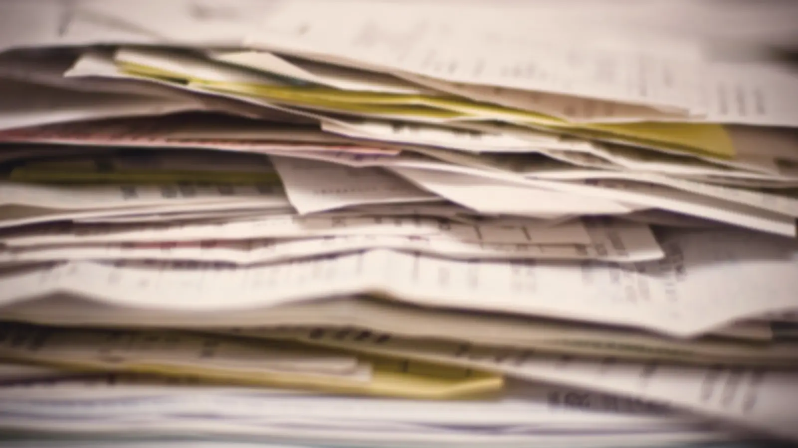 A messy pile of old receipts and paperwork
